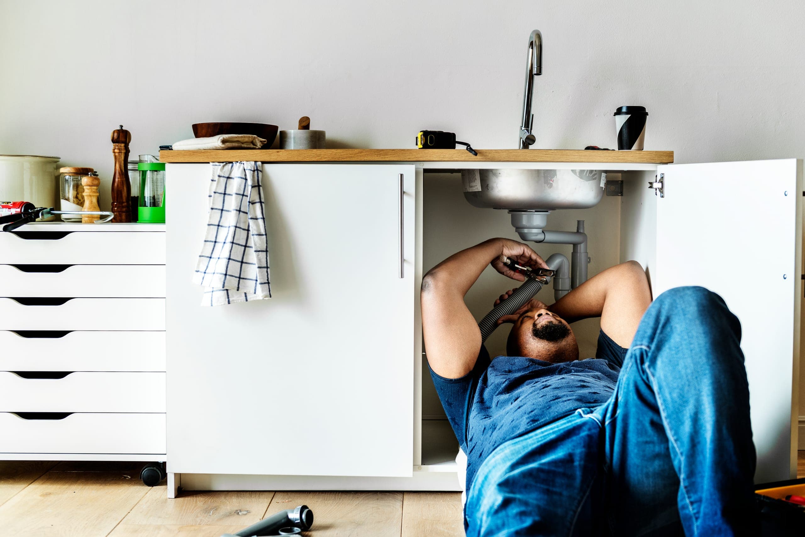 Plumber fixing blocked drains using specialized equipment